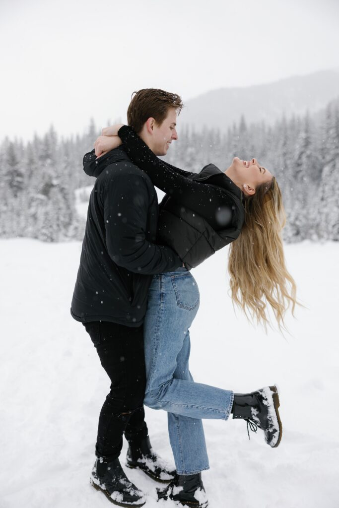 Couple pictured in the snow during their engagement session.