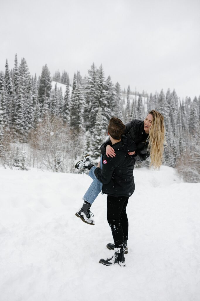 A couple laughing in the snow.