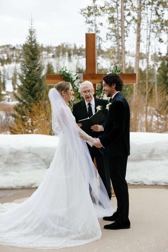 A outdoor wedding reception with snow in the background.